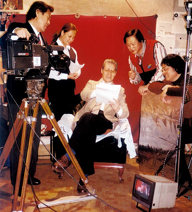 1999年十集电视系列片《爱国艺术家苦禅大师》在拍摄中，蓝天野担任此片艺术顾问和主持人，和本文作者李燕（右二)在讨论主持文字。.jpg